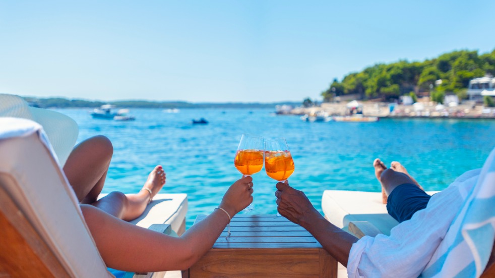 Couple by sea with drinks